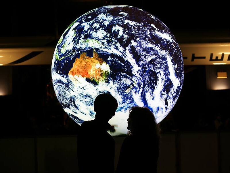 SOS Blue Marble with Couple Standing in front