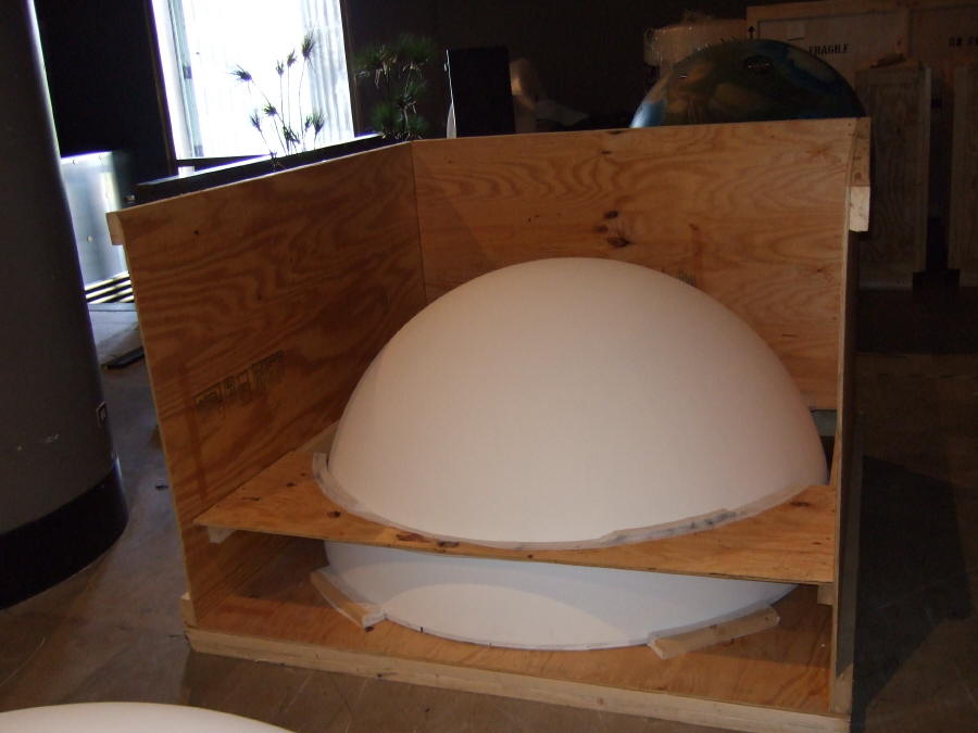 A Science On a Sphere packed in a crate. It is packed in two halves, with one half nested inside the other, with a plywood frame to keep the upper half from resting on the lower half